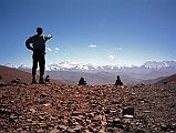 06 Jerome Ryan On Pang La - Makalu, Lhotse, Everest, Gyachung Kang, Cho Oyu Jerome Ryan points at the mountain panorama from the top of the Pang La (5250m) pass on the way to Everest North Face in Tibet. The view includes Makalu, Lhotse, Everest, Gyachung Kang (7952m) and Cho Oyu (8201m).